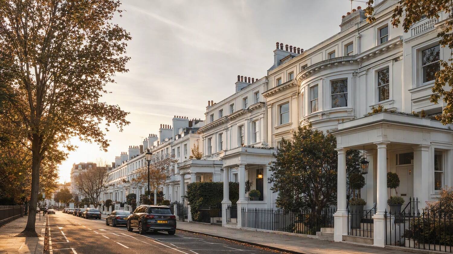 Elegant white stucco terraced houses in west London at golden hour